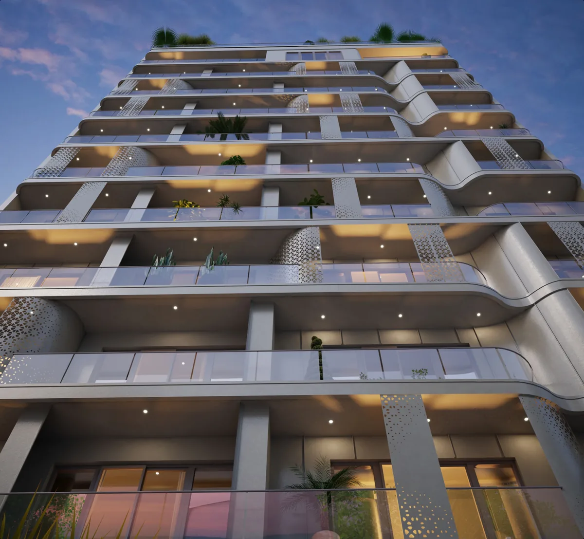 Façade de la résidence à la tombée du jour, balcons végétalisés éclairés